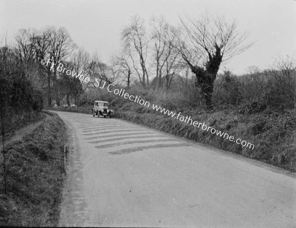 OLD CAR ON COUNTRY ROAD